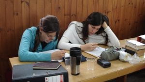 two women studying torah at a table